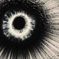 an eyeball is shown in the center of a black and white photo with rays coming out