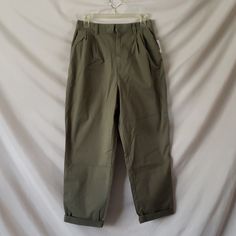 Cotton Olive Color Khakis With Front Pleats Spring Military Style Cotton Pants, Spring Cotton Military Pants, Military Style Relaxed Fit Pants For Spring, Olive Tapered Leg Pants For Spring, Spring Olive Tapered Leg Pants, Green Relaxed Fit Gap Bottoms, Gap Green Relaxed Fit Bottoms, Spring Military Style Khaki Bottoms, Military Khaki Bottoms For Spring