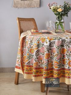 the table is set for two with flowers in vases