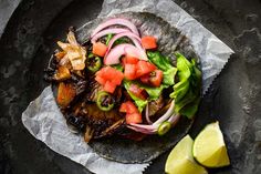 a close up of a plate of food with meat and veggies on it