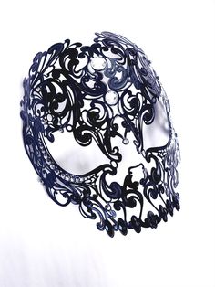 Steal the spotlight at any masquerade ball, costume party, or themed event with this edgy and bold metal skull masquerade mask. The mask features a filigree design with rhinestone embellishments. Our skull mask is lightweight and flexible, making it easy to mold perfectly to your face. 

Age Group/Gender - Adult/Unisex

Size/Type - One size fits all adults

Mask Color - Black

Mask Material - Metal

Accent Material - Rhinestones

Special Features - Filigree Design

Personalization - Not availabl Gothic Full Face Mask For Masquerade, Gothic Full Face Masquerade Masks, Black Skull Shaped Mask For Masquerade, Black Skull Mask For Masquerade, Skull Masquerade Mask, Black Lace Mask, Masquerade Ball Costume, Skull Masks, Masquerade Mask Black