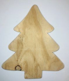 a wooden cutting board with a christmas tree on it