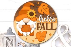 a wooden sign that says hello fall with an image of a gnome and sunflower