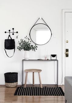 a living room with white walls and black accents