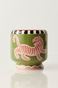 a green cup with a pink and white tiger on it