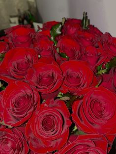 a large bouquet of red roses in a vase