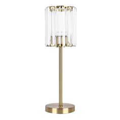 a gold and clear table lamp on a white background