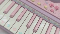 a pink keyboard with hello kitty decorations on it