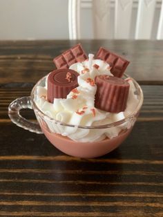 a glass bowl filled with whipped cream and chocolate