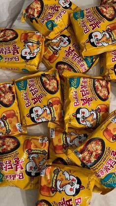 many bags of ramen noodles are shown in this photo, with the packets on top