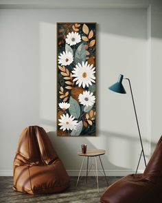 a living room with two leather chairs and a large painting on the wall above it