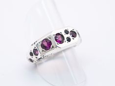 This stunning little sterling silver ring is set with 18 gemstones of varying size including several big beautiful pink garnets. Ring Face: 10 mm x 7 mmSize 7 1/4 Silver Pink Sapphire Multi-stone Ring, Formal Multi-stone Garnet Rings, Pink Garnet, Garnet Rings, Ring Size 7, Sterling Silver Ring, Garnet, Silver Ring, Sterling Silver Rings