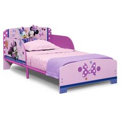 a child's bed with minnie mouse head on the side and purple sheets, in front of a white background