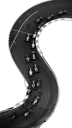 an aerial view of cars driving on a curved road