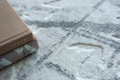 a book sitting on top of a white rug