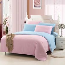 a bedroom with pink and blue bedding and a smiley face drawn on the wall