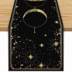 an image of a black and gold table runner with the moon on it's side