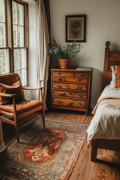 a bed room with a neatly made bed and a chair next to a large window