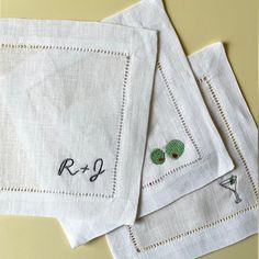 three embroidered napkins on top of each other