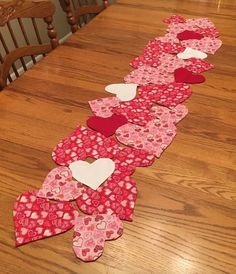 a long table with hearts cut out of it on the top and one in the middle