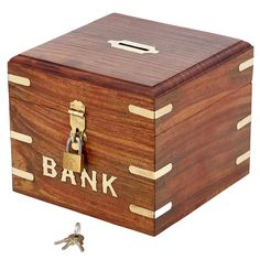 a wooden box with a lock on it and the word bank written in gold lettering