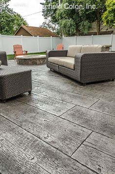 an outdoor patio with wicker furniture and wood flooring