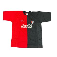 a black and red soccer jersey with coca cola on it's chest, sitting against a white background