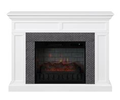 a white fireplace with an electric fire place in it's center and two candles on each side