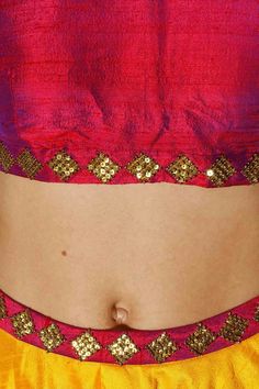 This lehenga choli components a yellow, hot pink and maroon crude silk lehenga with crisscross print and gota lines all over and sequins weaved waistband. It has an underlayer of can-can. It is matched with maroon crude silk pullover with gold sequins weaving in precious stone example on the neck area and fix and curtail. It likewise joins pink sequins weaved net dupatta. Navratri Party Lehenga With Motifs, Party Lehenga With Motifs For Navratri, Anarkali Choli With Motifs For Party, Pink Raw Silk Choli For Navratri, Pink Raw Silk Bollywood Choli, Bollywood Style Pink Raw Silk Choli, Pink Bollywood Raw Silk Choli, Festival Pre-draped Brocade Saree With Resham Embroidery, Pink Silk Choli With Mirror Work