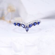 a blue and white ring with diamonds on it