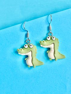 Cheryl the Crocodile Earrings Watch out... she's snappy... quirky, funky, fun and original.  If you would like a matching necklace in silver 925 please see my listing in the necklace section.  The hook is made of sterling silver to protect your ears and Cheryl is made from polymer. They come well presented and wonderful for a present for a friend, family, your loved one or a treat for yourself.  Thank you for taking the time to look at my earrings and please visit my shop for more original desig Quirky Hypoallergenic Dangle Earrings, Green Novelty Dangle Earrings, Quirky Hypoallergenic Dangle Jewelry, Green Hypoallergenic Novelty Earrings, Fun Dangle Earrings, Crocodile Jewelry, Crocodile Earrings, Silly Earrings, Novelty Earrings