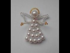 an angel brooch with pearls on it