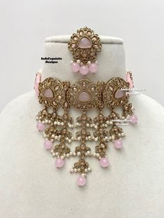 Elegant antique gold Polki pearls Choker Set with beautiful Jhumki earrings and Tikka/Indian Jewelry/ High quality kundan Polki jewelry/trendy choker/baby pink     All items are shipped from Brampton, Ontario, Canada. If you need your item by a certain day, please reach out to us for express delivery option before placing the order so that we can update the shipping for you. Standard shipping/delivery timeline Below are the estimated delivery times after the order is shipped/dispatched.  ---> US Traditional Rose Gold Jewelry Sets For Festive Occasions, Traditional Rose Gold Jewelry Sets For Festivities, Pink Chandbali Hand Set Jewelry, Festive Pink Jewelry Sets, Festive Pink Round Jewelry Sets, Festive Rose Gold Bridal Necklace, Pink Kundan Jewelry Sets, Pink Kundan Necklace For Festivals, Pink Chandbali Wedding Jewelry