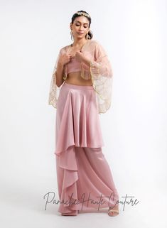 Introducing our stunning Dhoti skirt set, perfect for any special occasion! The skirt is made from luxurious satin fabric, which drapes beautifully and feels incredibly comfortable against the skin. The skirt features a unique dhoti style, which adds a touch of elegance and sophistication to the overall look. The bralette blouse is also made from the same lustrous satin fabric and features a flattering design that accentuates the shoulders and neckline. The combination of the dhoti skirt and bra Bollywood Style Silk Evening Sets, Silk Sets For Party With Traditional Drape, Elegant Pre-draped Saree With Tilla For Diwali, Elegant Raw Silk Sets For Navratri, Silk Draped Party Set, Navratri Party Organza Palazzo Set, Elegant Evening Sets For Diwali, Silk Sharara For Diwali Evening, Silk Sharara For Evening And Diwali