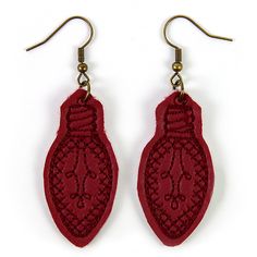 pair of red earrings with intricate design on white background