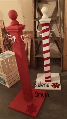 a red and white pole with snowflakes on it next to a christmas decoration