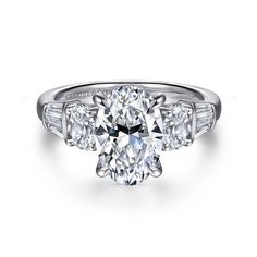 an oval cut diamond ring with three baguets on the side