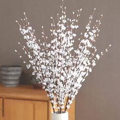 a vase filled with white flowers on top of a table