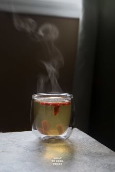 a cup filled with liquid sitting on top of a table