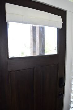 a brown door with a window and blinds