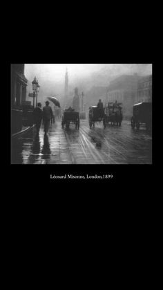 black and white photograph of people walking in the rain