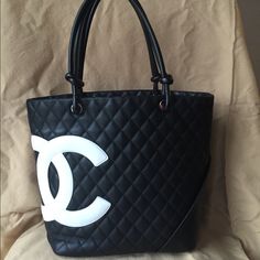 Reposhing This Item I Purchased From @Shakingfist. Authentic Black Chanel Cambon Tote With White Logo. Previously Authenticated By Poshmark When I Purchased And Will Be Again When You Purchase. I Will Include The Original Poshmark Authentication Card. Loved It, But It’s Been Sitting In My Closet Unused For 2 Years. Will Accept A Reasonable Offer. Please See Photos For Markings On Bottom Of Bag And Fading On White Logo. Chanel Cambon, Chanel #1, Chanel Jumbo, Chanel Tote, Nike Tennis Dress, Nylon Tote Bags, Pink Chanel, Chanel Purse, Nylon Tote