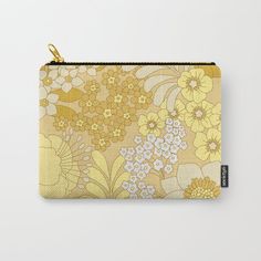 a yellow and white floral pattern carry - all pouch with gold zipper closure on the front