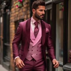 a man in a purple suit and pink tie is walking down the street with his hands in his pockets