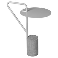 a white table with a concrete base and a metal handle on the top that is holding a round object