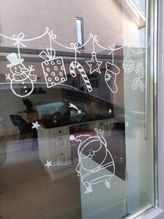 the window is decorated with christmas decorations and stickers on it's glass door