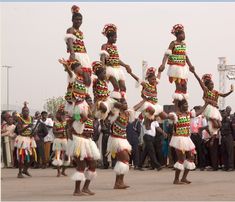 some people are dancing in costumes and headdresses