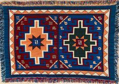 an old colorful rug with fringes on it