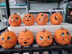 there are many pumpkins with faces painted on them