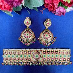 Jadau choker necklace set made in 92.5 gold plated silver, worthy of being worn with a bridal lehenga or attire. The stones in setting are precious freshwater pearls and synthetic rubies & emeralds. The hanging beads are real rubies and emeralds. Elegant Hand Set Lehenga For Festivals, Elegant Hand-set Lehenga For Festivals, Elegant Lehenga With Hand Set Details For Festivals, Festive Lehenga With Hand Set Details For Festivals, Ceremonial Lehenga For Festivals, Elegant Heavy Lehenga For Celebration, Bollywood Style Hand Set Choker For Celebration, Bollywood Hand Set Choker For Celebration, Hand Set Temple Jewelry Choker For Diwali